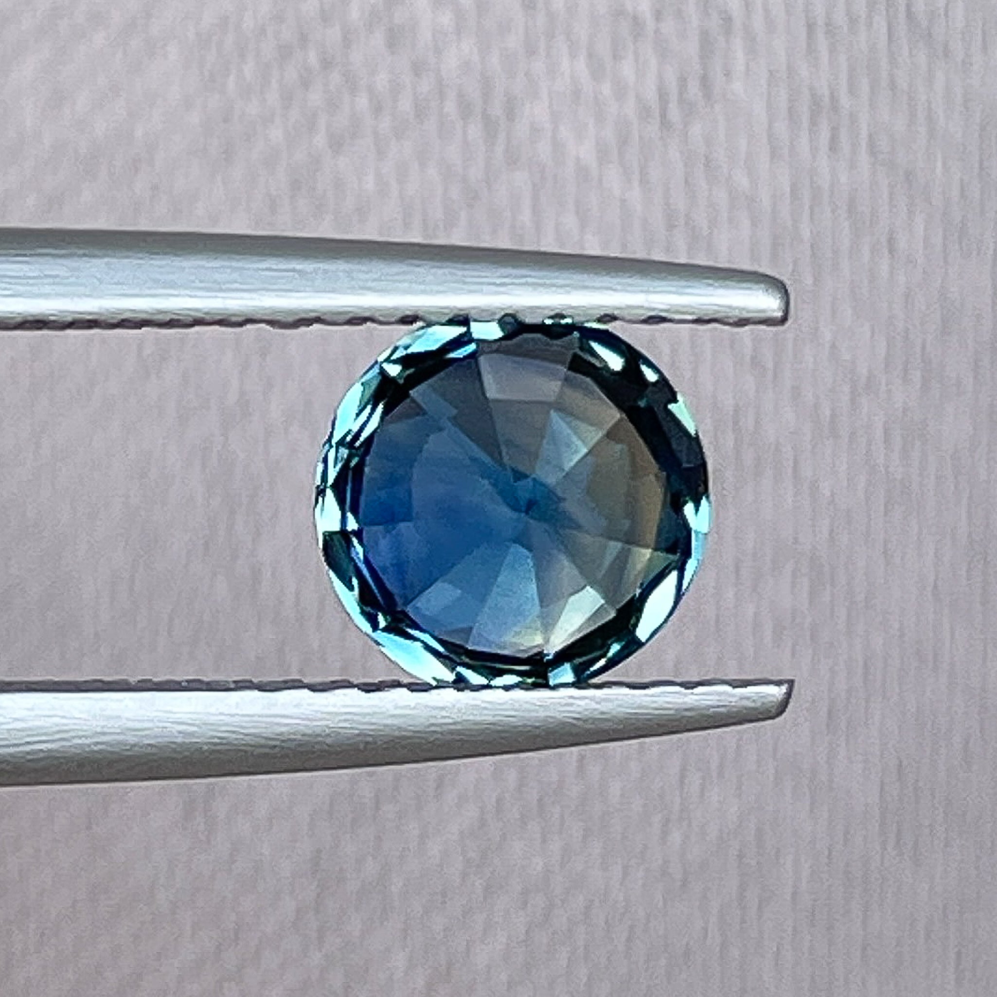 Natural teal blue sapphire 1.65 ct round cut loose gemstone from NASHGEMS, ideal for engagement rings or custom jewelry.