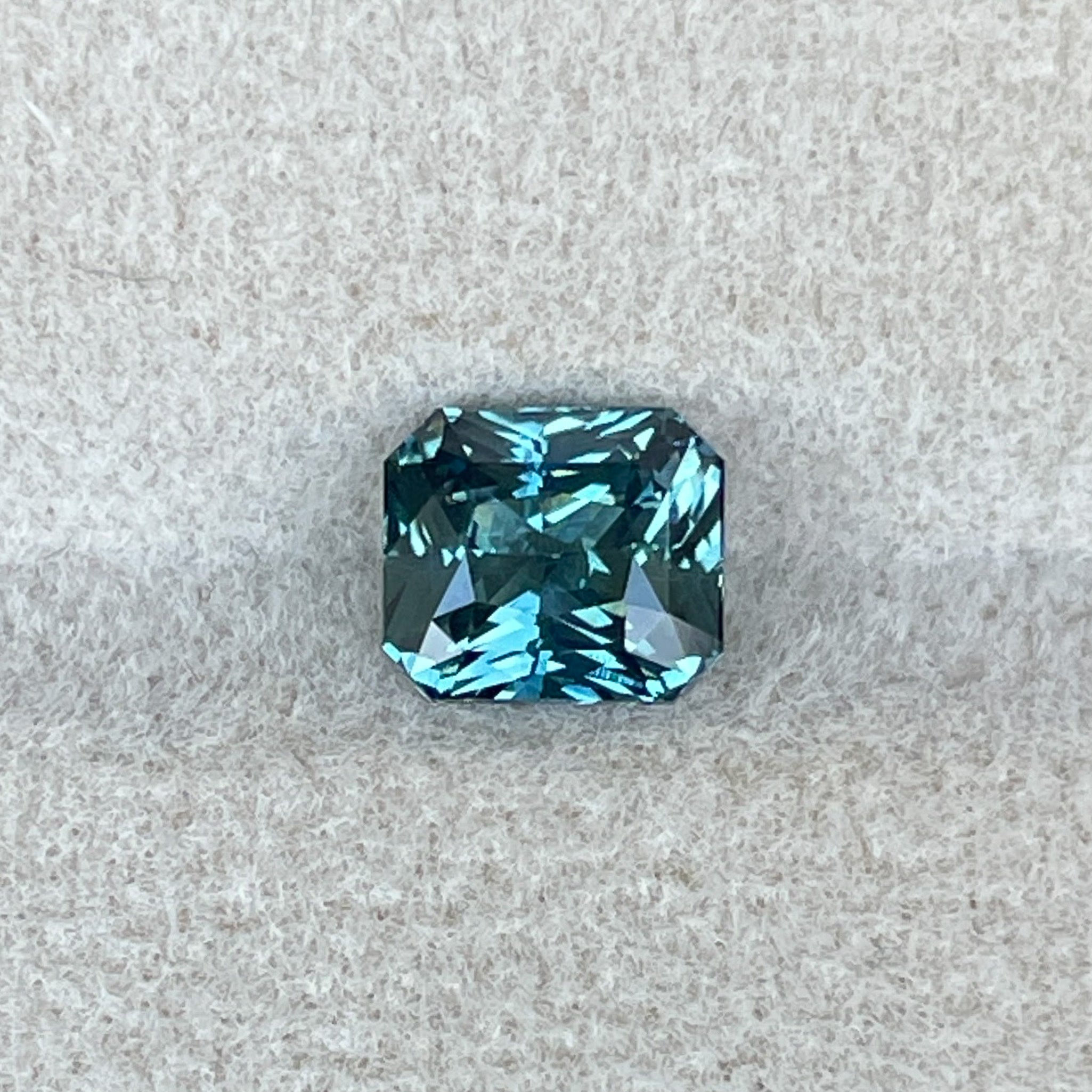 Natural teal sapphire by NASHGEMS, 1.73 Ct radiant cut loose gemstone ideal for engagement rings or custom jewelry.