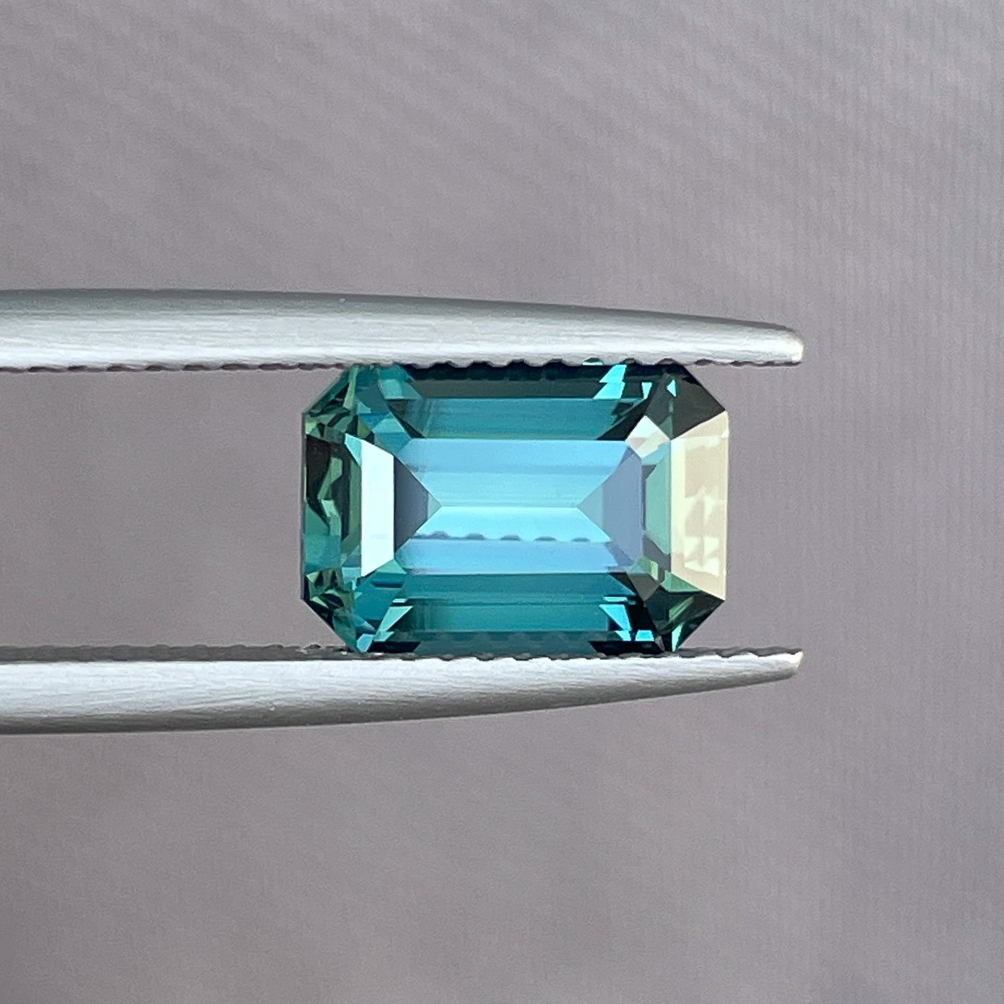 Natural teal blue-green sapphire, 3.71 Ct emerald cut loose gemstone from NASHGEMS, ideal for engagement rings or custom jewelry.