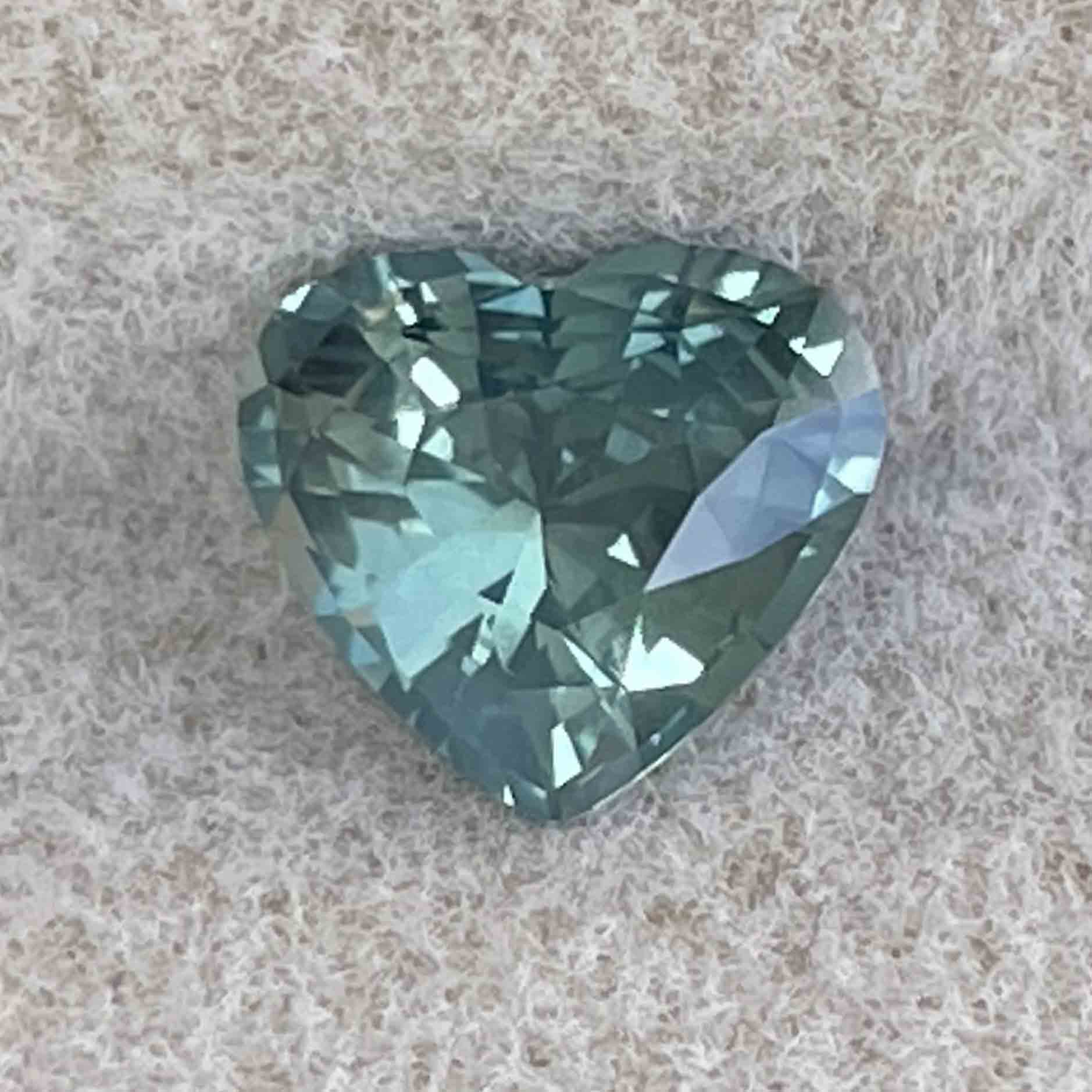 Teal green sapphire heart-shaped loose gemstone, 1.12ct, heat-treated for custom jewelry or engagement rings, by NASHGEMS.