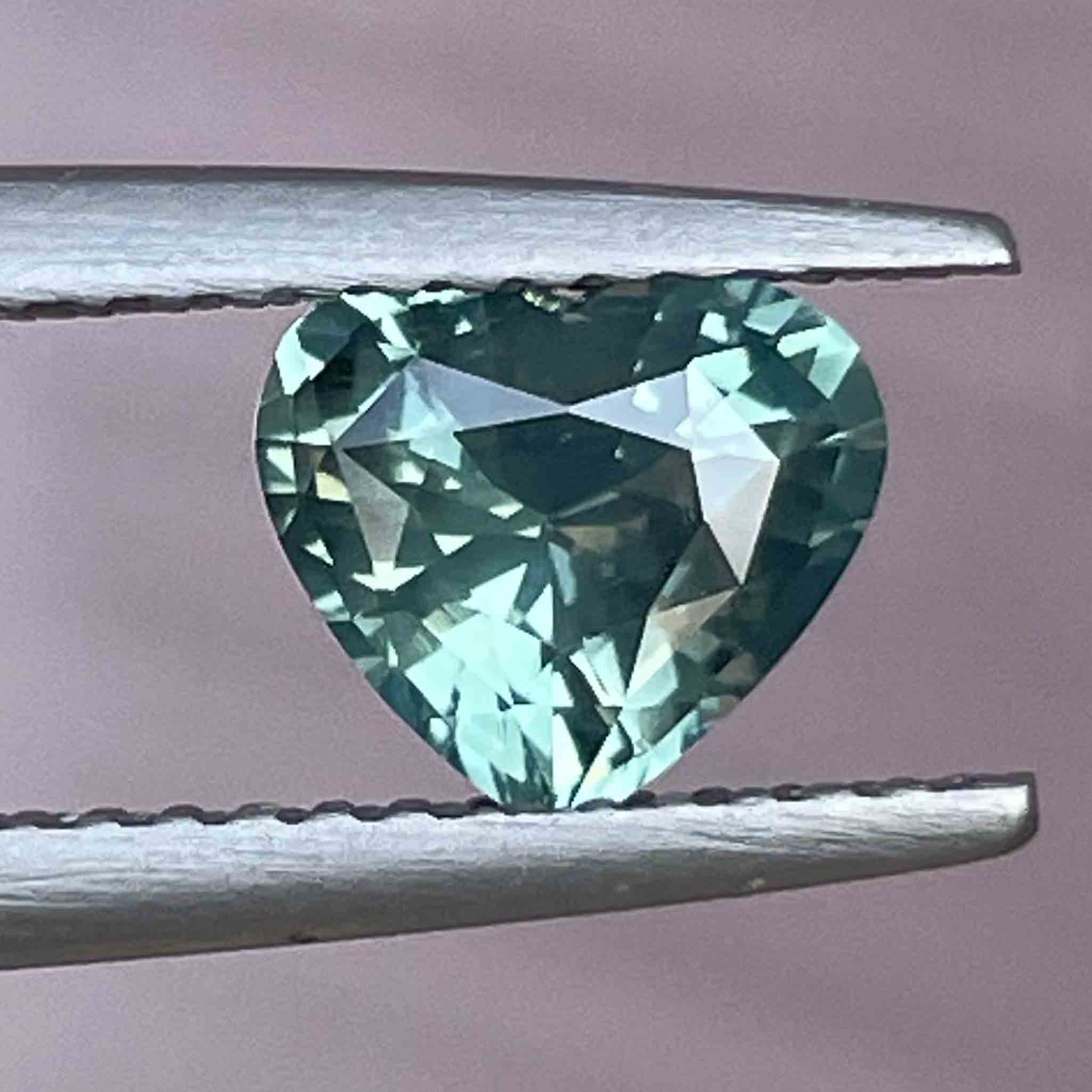 Teal green sapphire loose gemstone, 1.12 carats, heat-treated, from NASHGEMS, suitable for engagement rings or custom jewelry.