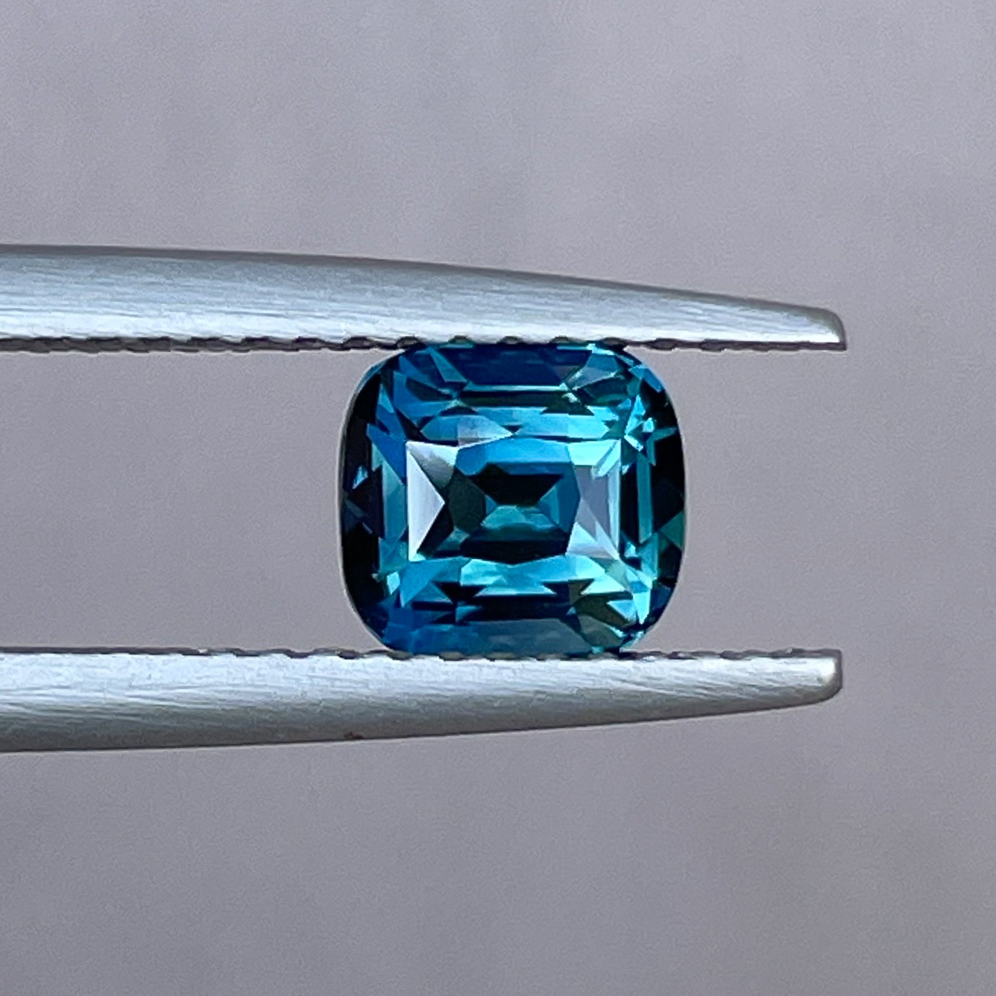 Natural teal blue sapphire loose gemstone, 1.52 ct cushion cut by NASHGEMS, ideal for engagement rings or custom jewelry.