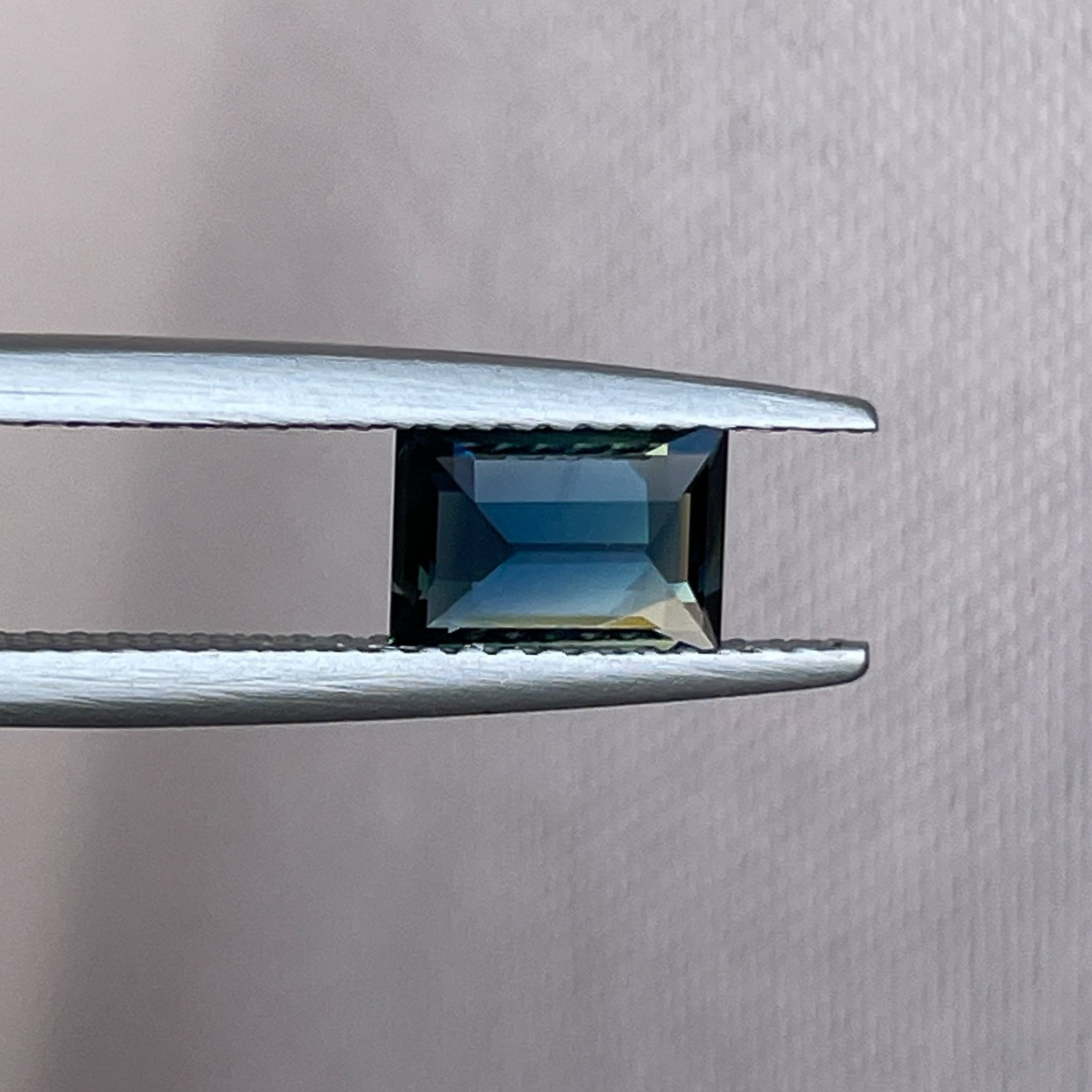 Natural teal blue sapphire 1.15 Ct in baguette cut, loose gemstone by NASHGEMS, ideal for engagement rings or custom jewelry.